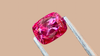 Stunning pink cushion-cut spinel, sourced from Myanmar. The gemstone’s vivid color is highlighted against a soft beige background, ideal for custom jewellery designs.