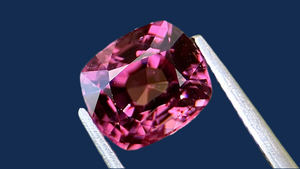 Vivid cushion-cut natural spinel gemstone in a striking purple hue, sourced from Myanmar. Measuring 7.1x6.2x4.8mm, this exceptional gemstone is perfect for bespoke fine jewellery and luxurious engagement rings in the UK and Europe.