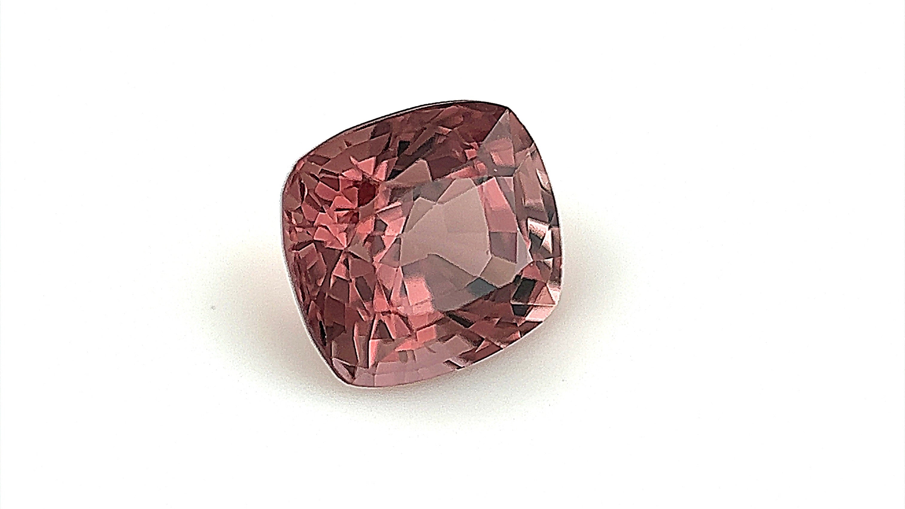 Rare deep brown natural spinel gemstone, dimensions 6.8x6.2x5mm. Photographed with a gemlight box to enhance its deep colour and clarity, perfect for creating a unique engagement ring.